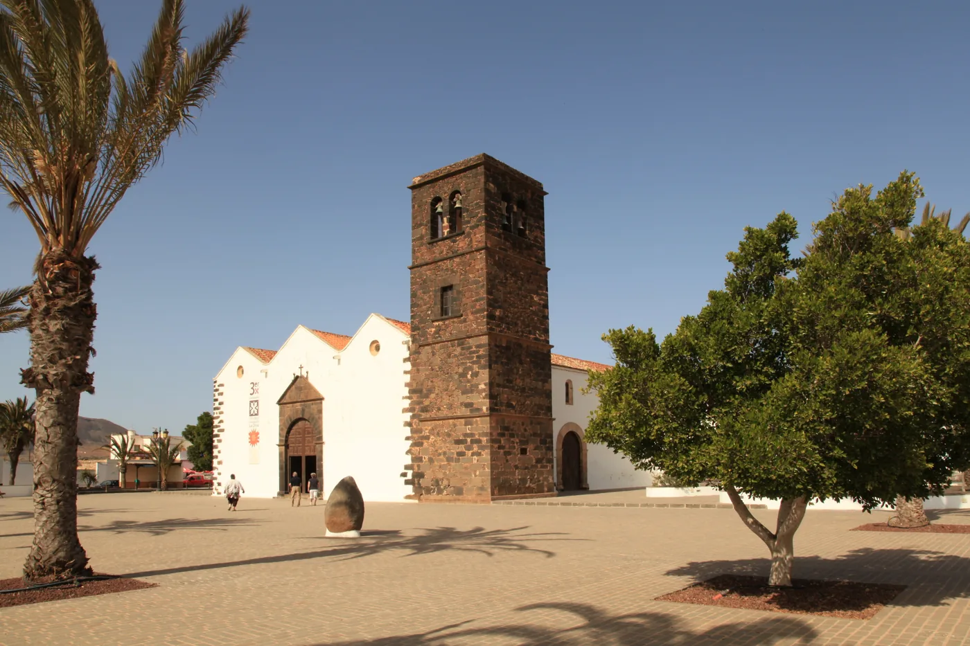 The church of Nuestra Señora de la Candelaria with its square stone tower on the church square of La Oliva, Fuerteventura.