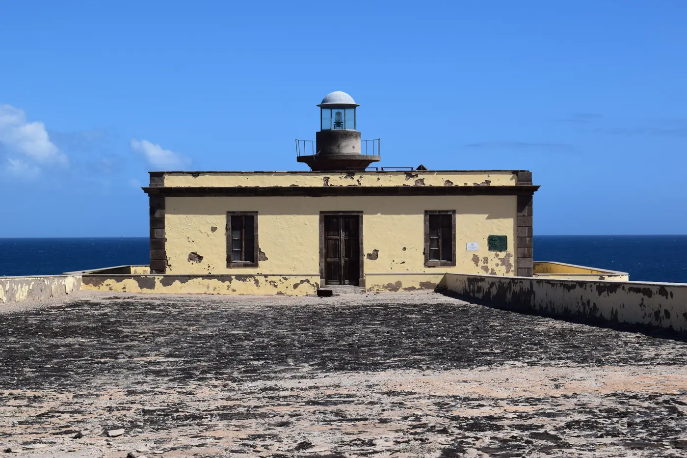 The Martiño lighthouse on Lobos, white tower on bare volcanic ground