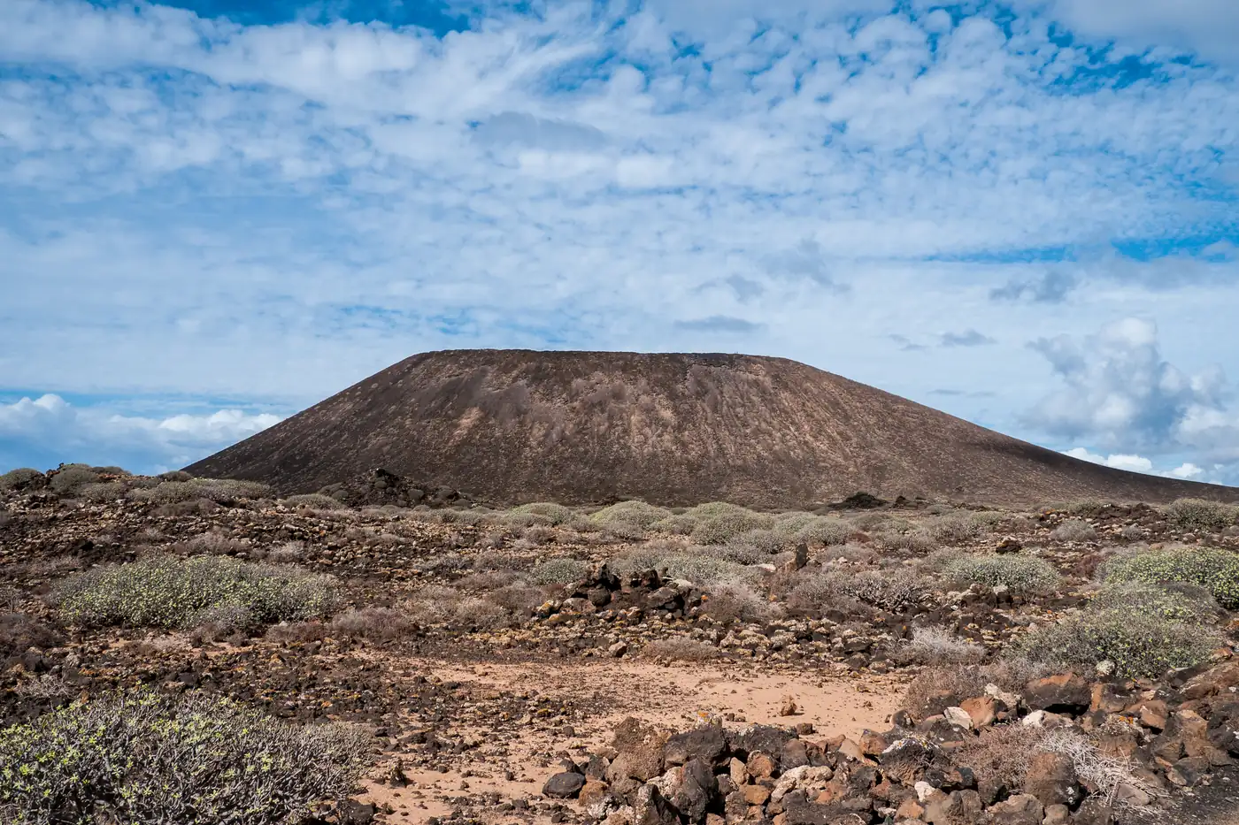 Montaña de la Caldera rising above volcanic scrub on Isla de Lobos, Fuerteventura.