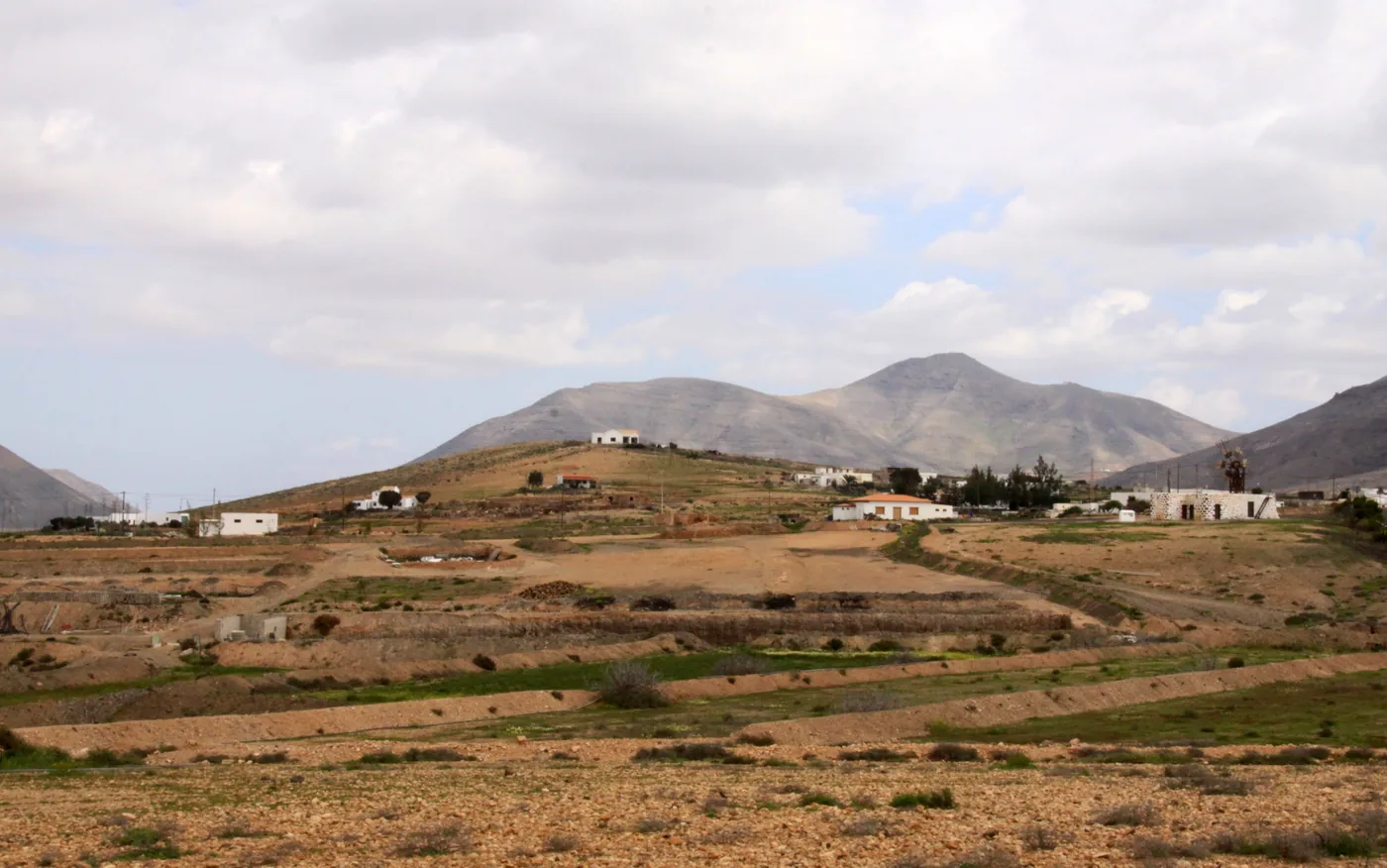 Fields and scattered houses at Tefía below bare mountains, Fuerteventura.