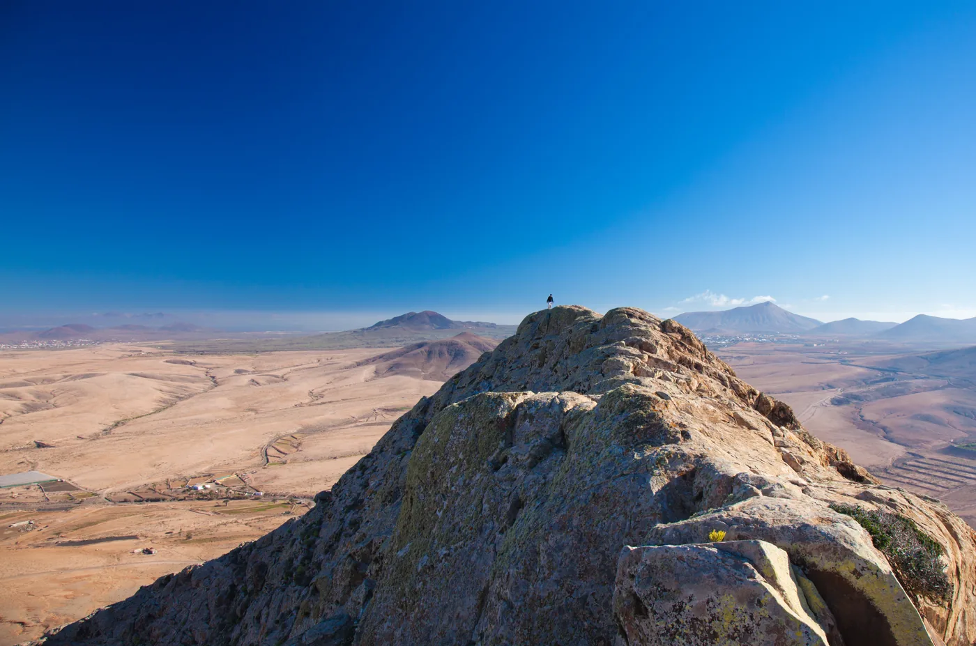 The view north from Tindaya mountain over the flat plain to the coast
